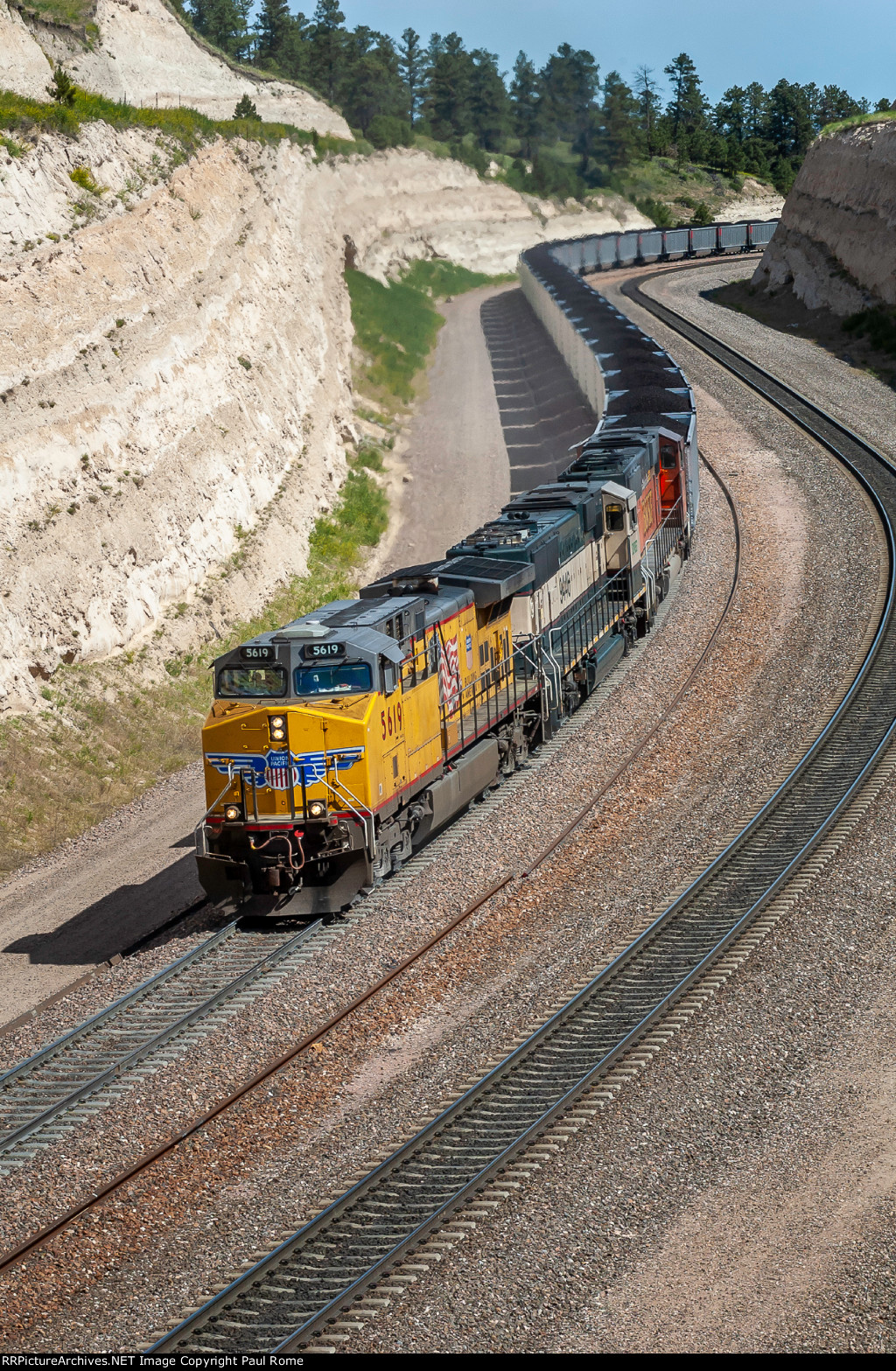 UP 5619 and BNSF 9446 and 9480 power the eastbound Jefferies Energy coal train snaking its way over the summit of Crawford Hill